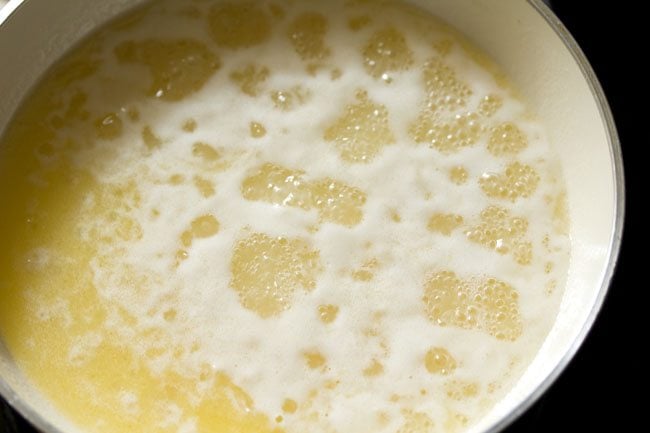 butter water solution simmering in the pan to make atta cake