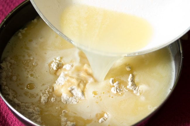 butter mixture being poured to the bowl with flour, condensed milk and vanilla