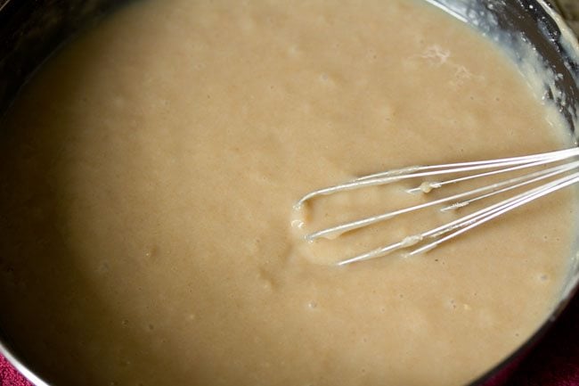 prepared wheat cake batter with whisk in it