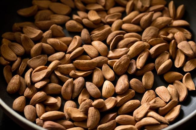 roasting almonds in the pan for badam laddu. 