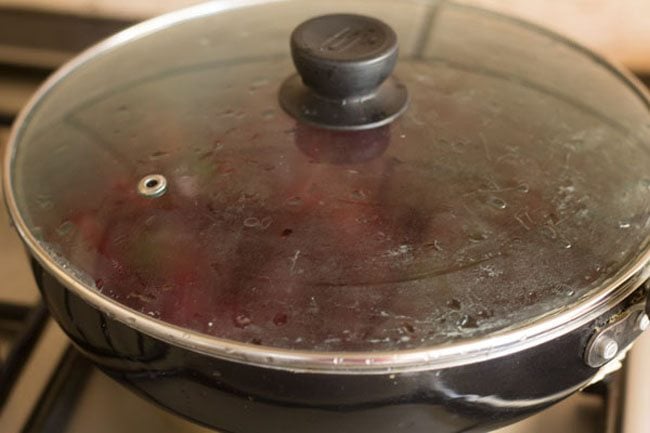 cooking beetroot bhaji with lid kept on pan