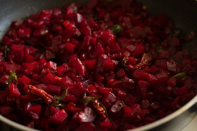 stirring beetroot bhaji