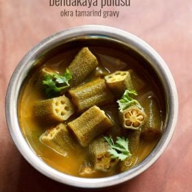 bendakaya pulusu garnished with coriander leaves and served in a steel bowl with text layovers.