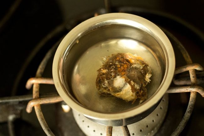 Soak tamarind in hot water to make Bendakaya curry. 