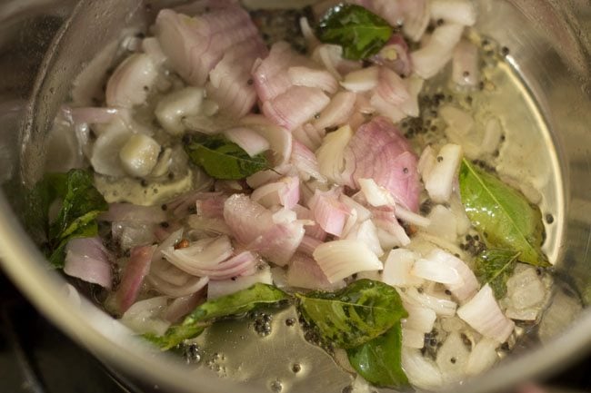 Add chopped onions to the pan to make Bendakaya curry. 