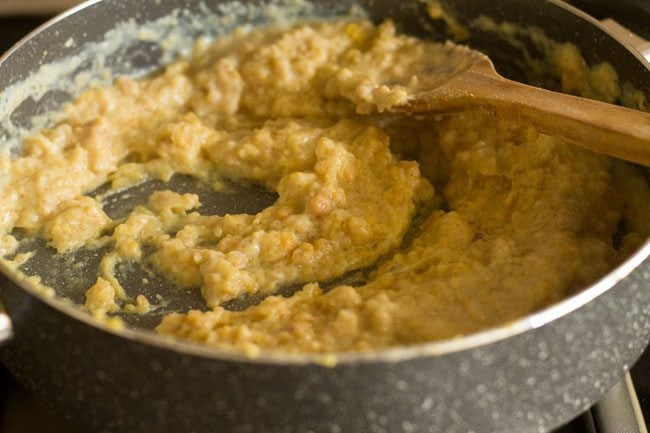 stirring and cooking besan halwa mixture