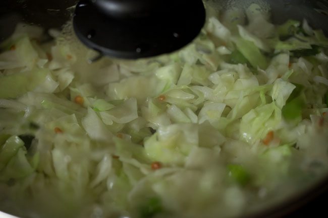 glass lid on pan with cabbage steaming inside