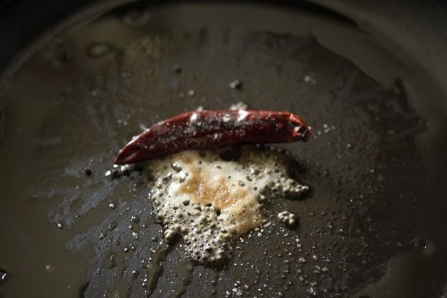 red chillies and asafoetida in pan