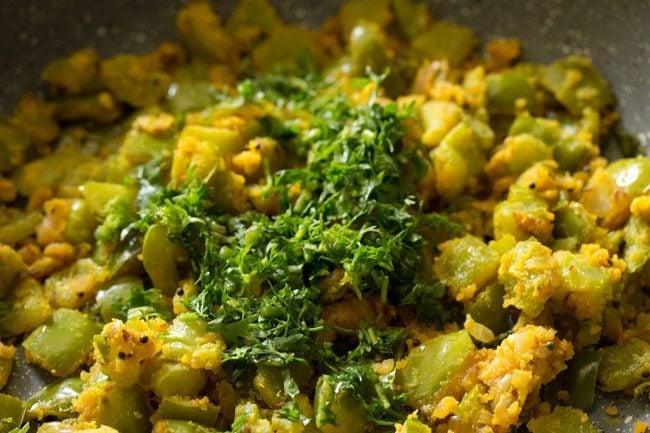 coriander leaves added to capsicum besan bhaji 