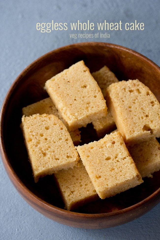slices of wheat cake kept neatly in a wooden bowl on a light grayish blue board