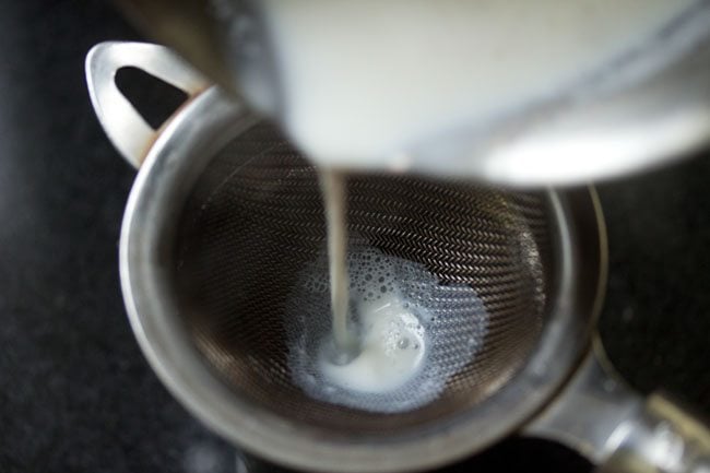 strain milk poured into cup