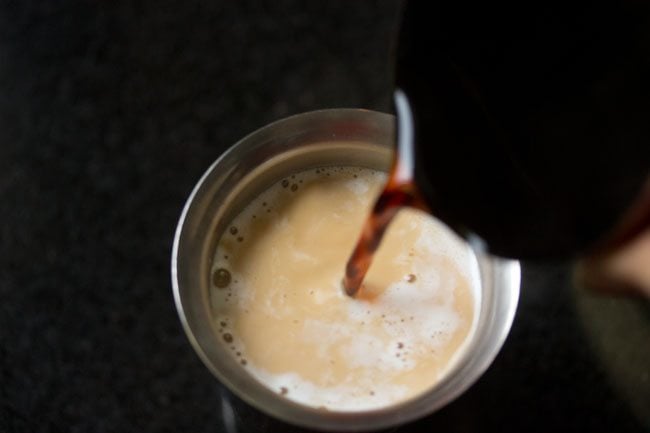 brewed coffee being poured into hot milk mixture