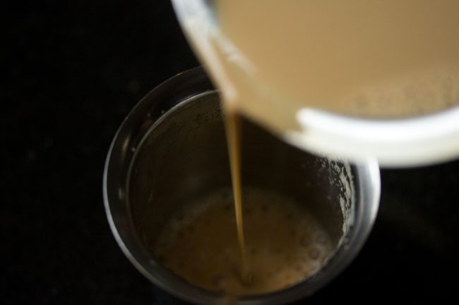 Coffee being poured back into the tumbler