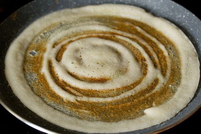 cooking ghee roast dosa.