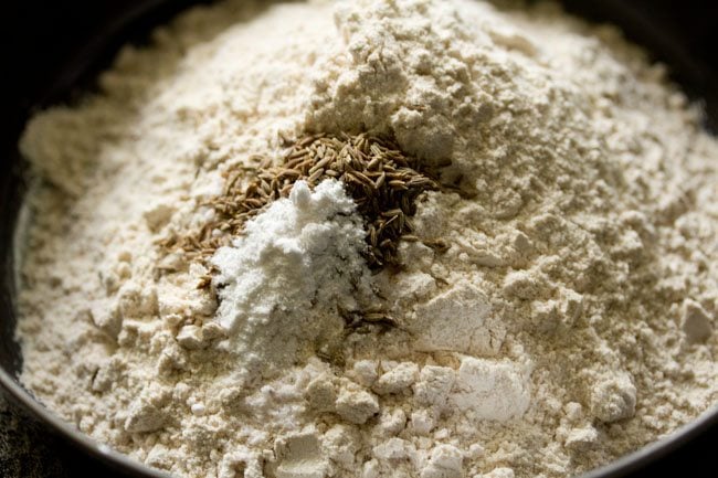 Place whole wheat flour, ground cumin seeds, baking powder and salt in a bowl.