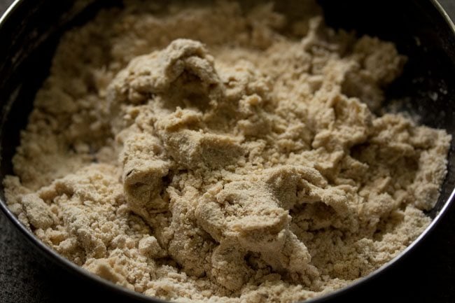 kneading flour mixture to make the dough for khasta roti. 