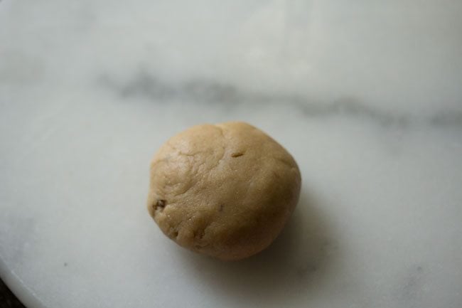 dough ball placed on a rolling board. 