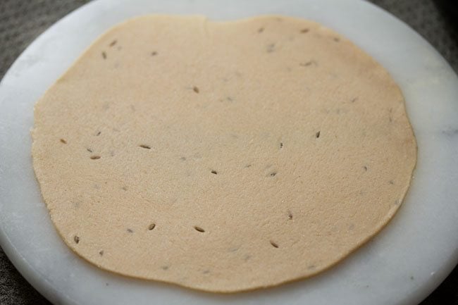 roll dough ball into a regular size chapatti. 