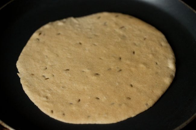 khasta roti placed on a hot tawa. 