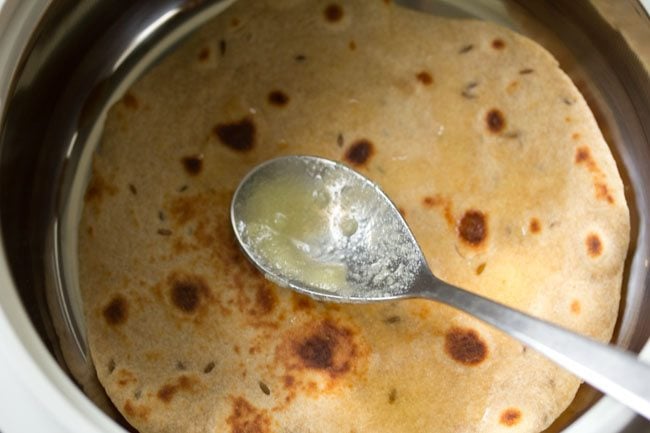 Spread ghee on the cooked hastaroti. 