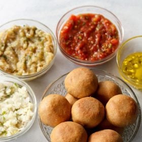 litti chokha served in glass bowls.