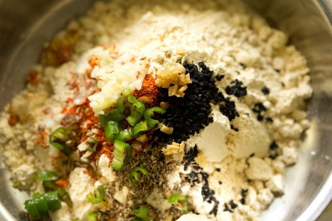 chopped green chilies, finely chopped ginger and finely chopped garlic added to the bowl for making stuffing for litti. 