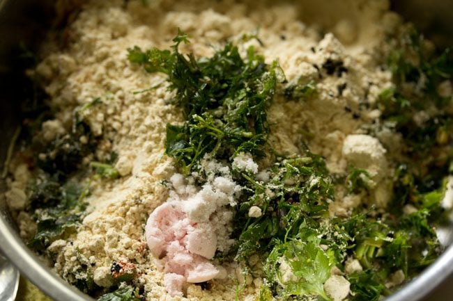 chopped coriander leaves, black salt and regular salt added to the bowl. 