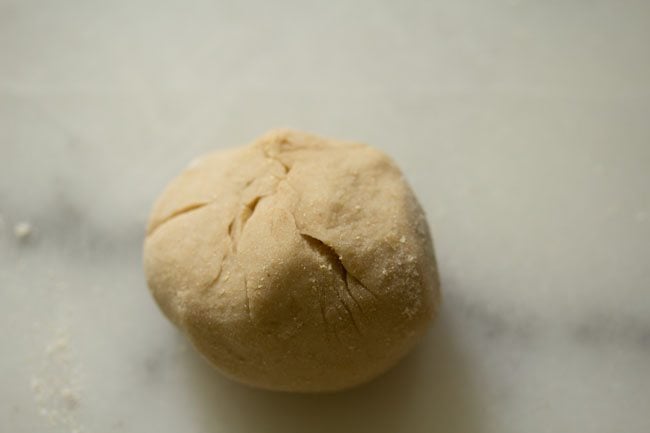 outer dough cover brought together in the center and pressed to make the stuffed litti. 