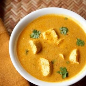 paneer curry garnished with coriander leaves and served in a white bowl.