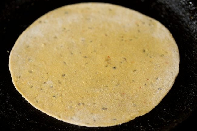 rolled paratha placed on tawa