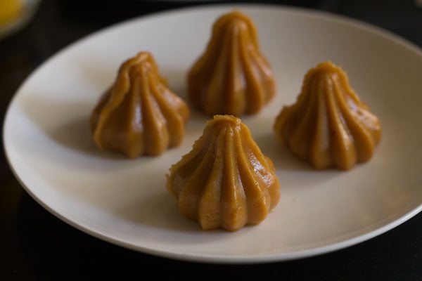 prepared mawa modaks on a greased plate. 