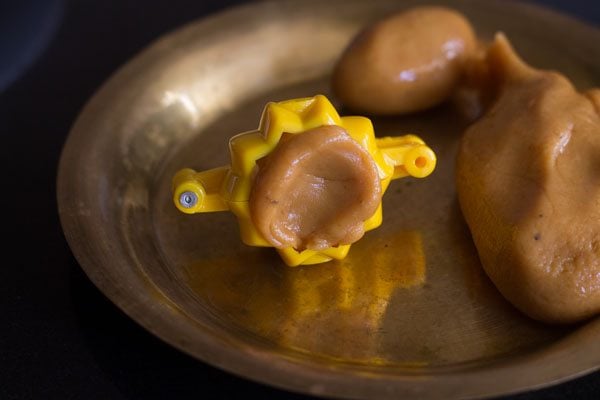 small mawa ball placed in the greased modak mould. 