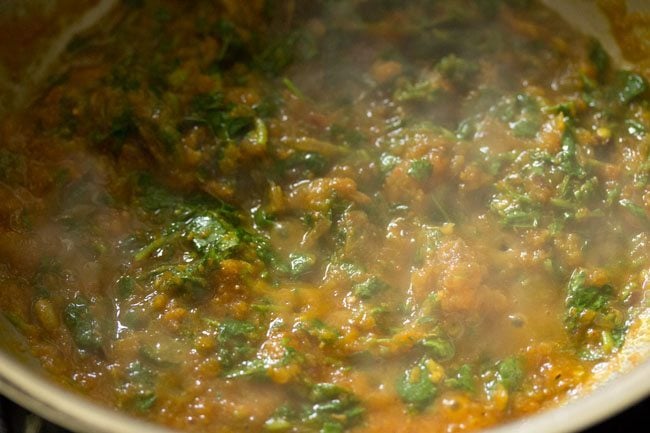mixing methi leaves with the mixture