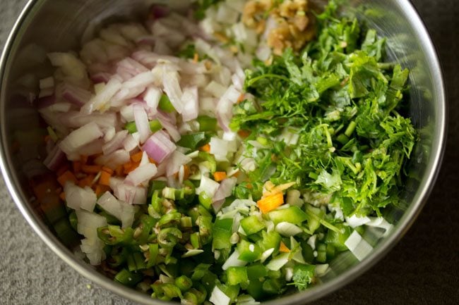 mix veggies and herbs in a steel bowl