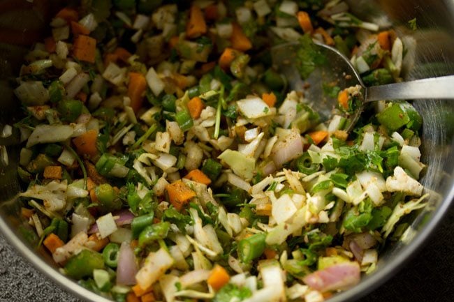 veg pakora ingredients mixed with a spoon