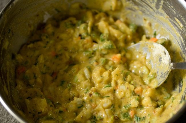 batter mixed with spoon to make vegetable pakoda