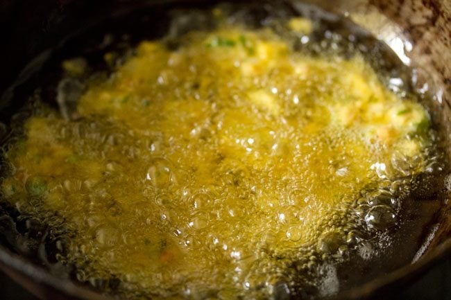 veg pakora frying in hot oil