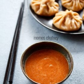 momos chutney served in a bowl with chopsticks on the side, momos on a platter above and text layovers.