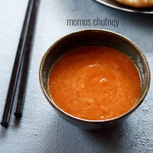 momos chutney served in a black bowl.
