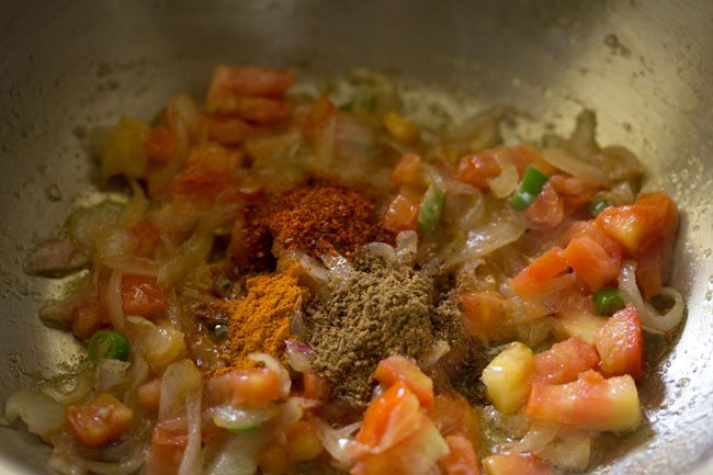 spices added to mixture in pan