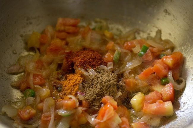 spices added to mixture in pan