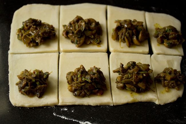 mushroom puff stuffing placed on rolled and cut dough