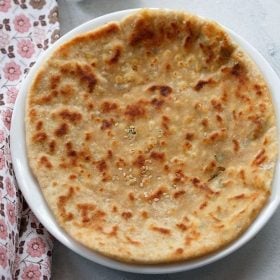 paneer kulcha served on a white plate.