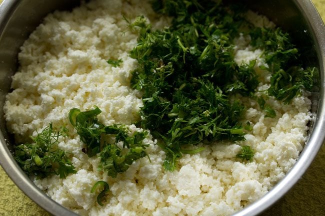 chopped green chilies and chopped coriander leaves added to the crumbled paneer. 