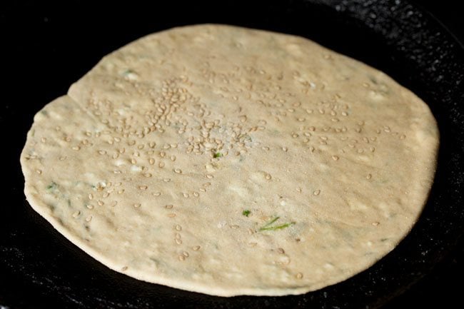 roasting paneer kulcha on a tawa. 