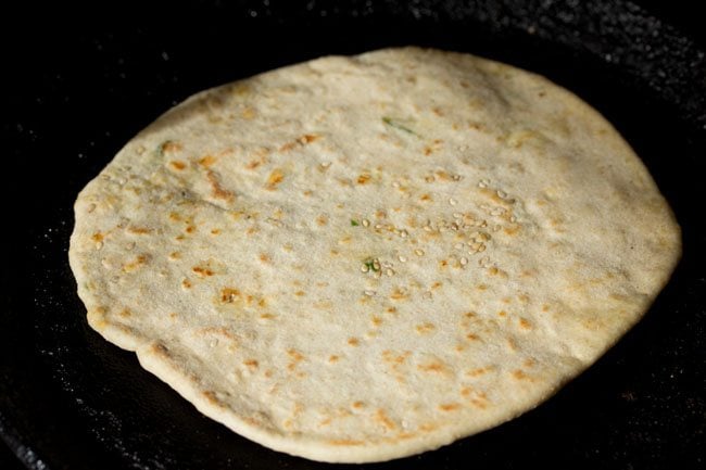 roasting paneer kulcha on a tawa. 