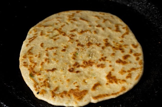 roasting paneer kulcha on a tawa. 