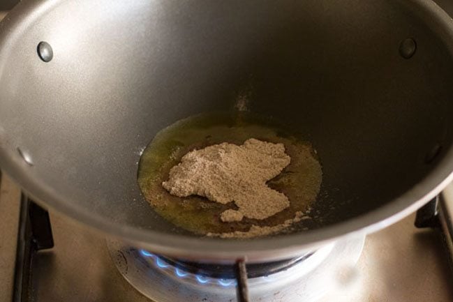 ragi flour added to hot ghee in the pan. 