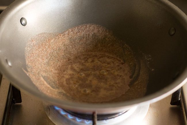 roasting ragi flour in hot ghee. 