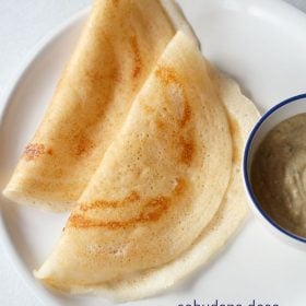 sabudana dosa folded and served on a white plate with a bowl of chutney kept on the left side and text layovers.